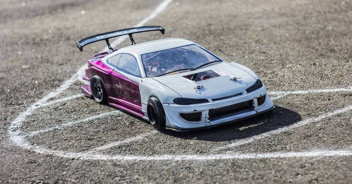 A model RC on-road car turning on a track.