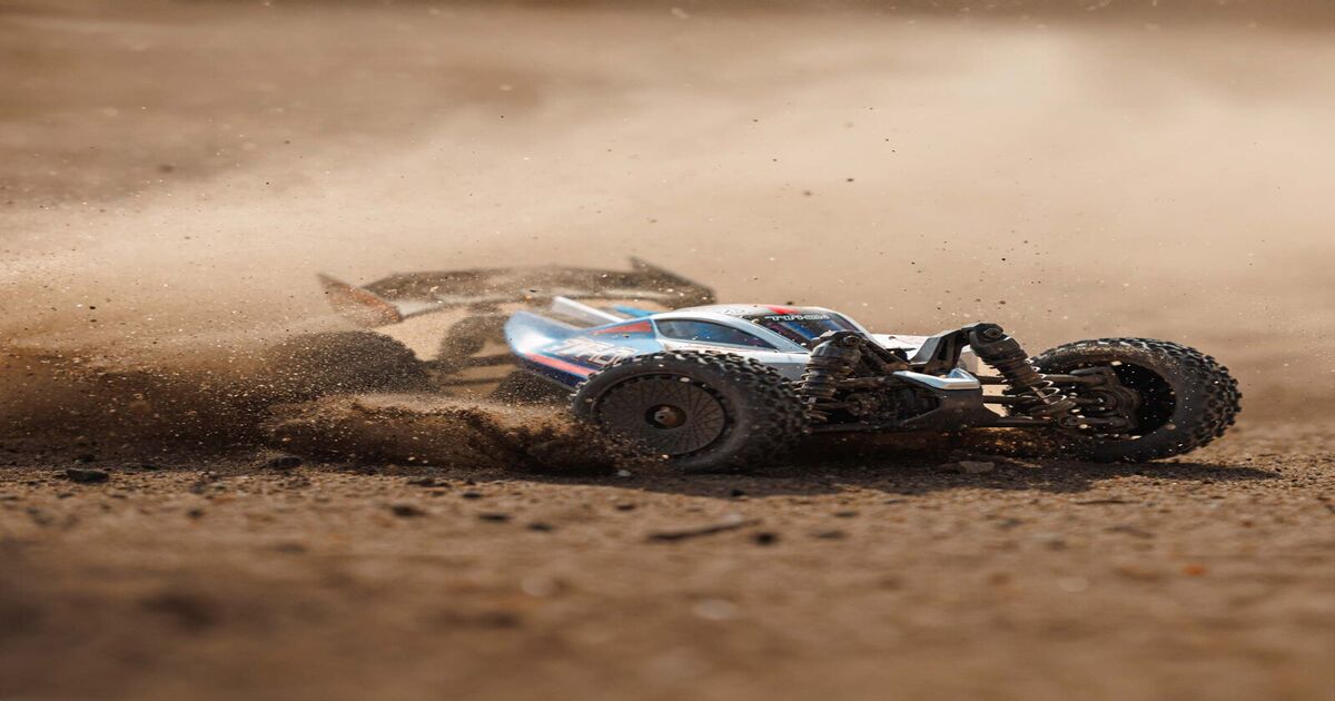 A Typhon Grom driving over sand dunes.